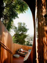 Redwood walls and stairs lead to the pool area, which overlooks spectacular views of L.A.