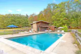 In addition to the main house, the property includes a pool house, pond, and heated saltwater pool.