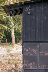 The hitch end of the trailer has storage for wood.