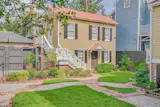 A two-unit carriage house sits in the backyard.