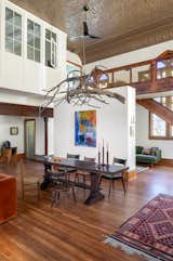 Studio IQL custom-designed the dining room chandelier made from branches.