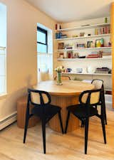 The two double-shelf storage cabinets built into the fluted base are an additional small space-friendly feature of the Transformer Round dining table.