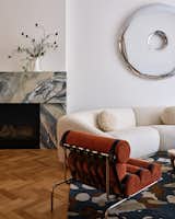 A dramatic stone surround for the hearth keeps to the client’s preferred neutral-forward palette, but adds visual interest, texture, and a bit of warmth, too.