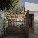 Inside the front door is one of several terra-cotta breeze-block walls that form semiprivate courtyards for each of the property’s units.