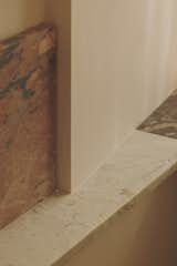 A detail shot of the backsplash and vanity top reveals the clever way the offcuts were fit together. Frosterley, Ledmore, Swaledale Fossil, and Stoneycombe are arranged according to the existing and available slab dimensions.