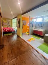 Even in spaces where the home’s shipping container structure is less obvious, bright colors and eccentric decor match the overall look.