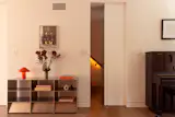 A pocket doors conceals the stair leading from the living area to the family’s bedrooms and the third-floor rental.
