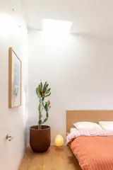 A Velux skylight brings natural light into the bedroom in the rental unit.