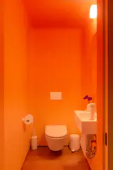The bathroom on the main level is a custom paint job, an ombre that blends Jeweled Peach and Honey Burst, both from Benjamin Moore.