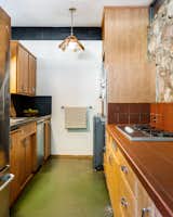 Jade-hued concrete floors span from the living room to the kitchen.