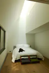 The couple’s sparsely furnished bedroom includes a pair of Japanese handcrafted low chairs.