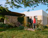 The home is surrounded by vegetation. The outdoor living and dining area is set roughly 50 feet from the swimming pool.