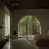 An arched glass door leads to a patio.