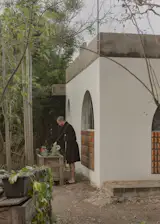 Ignacio tends his garden outside the kitchen window.