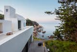 The ground-floor study, the living room on the second floor, and the dining room above are all oriented toward the sea.