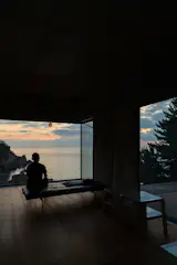 Architect Wook Choi watches the sea from the living room of the home he built with his wife, artist Jinnie Seo, in Goseong, South Korea.