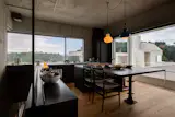 The top floor holds the kitchen/dining area, a roof deck, and a small tearoom.