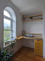 Graci works from home so she turned a former closet in the living room into an office. “I always get frustrated at how inefficient closets are,” she says, noting how the very top of the space is difficult to access because doors are usually so much lower than the ceilings. Andrew designed and built a custom workstation for her, which takes advantage of the full width and height of the nook and has a surface that can be collapsed into the desk.