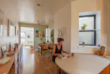 The kitchen window looks into a light well and neighbor’s apartment. To establish privacy without blocking out the sun, Andrew covered the glass in hardware store contact paper—an inexpensive staple on film and television sets.