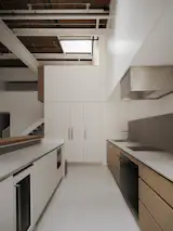 The minimalist kitchen is open to the nearby living area.