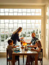Matilde Girão and Ricardo Lima set the dining table within the kitchen, to make the most of the early light and enjoy the view through the organic-shaped lattice. In rethinking the interiors, they wanted to maintain a dialogue with the building’s architecture and the surrounding urban scale.