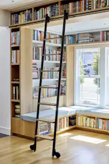 Poon custom-ordered a ladder to make it easy to access a top row of books.