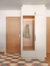 The renovated entry features terrazzo tile and a miniature “mudroom” that contains concealed cubbies for each family member.