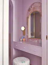 “I chose the pink and purple,” the couple’s daughter says about her bathroom and powder room, the latter of which is a mirror image of Brianna’s on the other side of the wall.