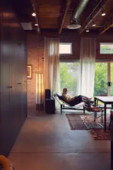 Amy sits beside a 1960s John Keal floor lamp designed for Modeline of California.