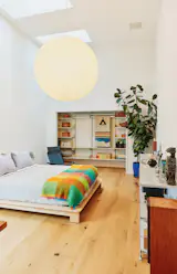 In the guest bedroom, an Akari 120A pendant lamp by Isamu Noguchi hangs above a Decimo Bed from Veta and a NychairX by Takeshi Nii.