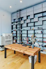 Will’s office features Parke MacDowell’s steel bookshelf system. It’s mounted to a new sheer wall with a deep footing, making it sturdy enough to hold an entire wall full of books.