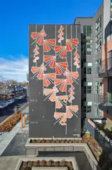 In 2025, Fettingis installed a mural of her characteristic geometric botanicals down the side of the Modera University Park building built by developer Mill Creek in Denver. She says residents talk to her while she’s working on her pieces and have shared 