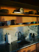 The kitchen faucet is from Moen, the quartzite kitchen countertops are from Formation Stone, and the drawer pulls are from CabinetParts.com.