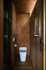 A door in the corner of the living room leads to a bathroom.
