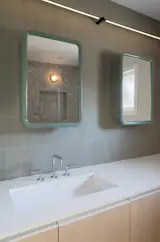 Solk specified shower terrazzo tile from Concrete Collaborative and backsplash tile by Heath in the bathrooms, as shown in the primary bath.