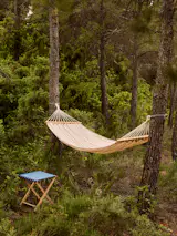 The collection's hammock is available in blue, black, or red stripes.
