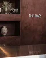 A bar greets guests at the entrance and facilitates events and after-hours programming.