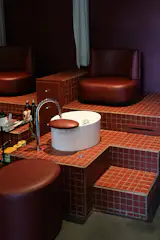 Cure’s tiled foot bath stations are awash in soothing earth tones and atmospheric lighting.