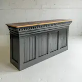 Inspired by old general store counters, Shepherd and Dubay crafted a black bar using pieces of salvaged wood, trim, and paneling.