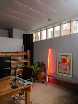 Hyduk designed a new music studio for DJ and producer Roni Amitai in 2025. The space is wrapped in modular, low-cost felt panels—some perforated and backlit—that improve acoustics.