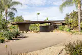 Designed by architect Lloyd Ruocco for a local contractor, this low-slung home has redwood framing, stone walls, and views of the surrounding mountains.