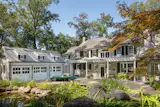 The entry to a historic family home in Sands Point, New York, embraces the classic architectural detail of the 1930s design, inviting multiple generations to comfortably gather. "We stayed true to the original architecture," Smiros says of the carefully considered renovation. "It reads as a continuing story."