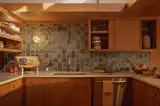 Nick redid the kitchen, adding custom tile from Mexican brand Lofa to break of the home’s swaths of wood.