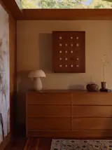 Nick designed a cabinet using wood from an old fence and inserted ceramic balls impressed with his grandfather’s thumb.