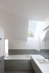 To maintain privacy from neighbors on either side of the home while still bringing in light, La Dallman inserted skylights, as in the primary bath.