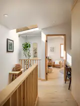 The bedrooms, bathrooms, and an office nook are upstairs. Chelsea used budget-friendly pre-engineered wood flooring from Stuga Astrid on this level.