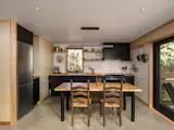 Chelsea chose Ikea Sektion cabinets with Kungsbacka anthracite door panels for the kitchen. The 30-inch induction stove is from Samsung, the hood is by Hauslane, and the fridge and freezer are by Blomberg, which she bought from a local appliance store that does servicing. She made the dining table out of the same butcher block she used on the counters plus three-inch round legs from Semiexact. The sink and faucet are from Kraus.