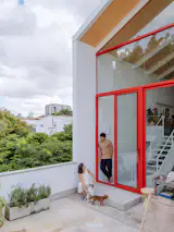 If the outdoor kitchen and patio behind the home are an improbably quiet refuge from teeming São Paulo, the terrace is comfortably urban, with views that embrace the surrounding city.