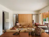 The Kofi coffee table is from Hay. The teak Jeanneret lounge chairs are from Srelle. The oak wall unit was designed by Anna and Eugeni Bach.
