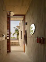 Bathrooms, like the rest of the rooms in the sprawling structure, are walled in concrete. The fixtures are from Porcelanosa.